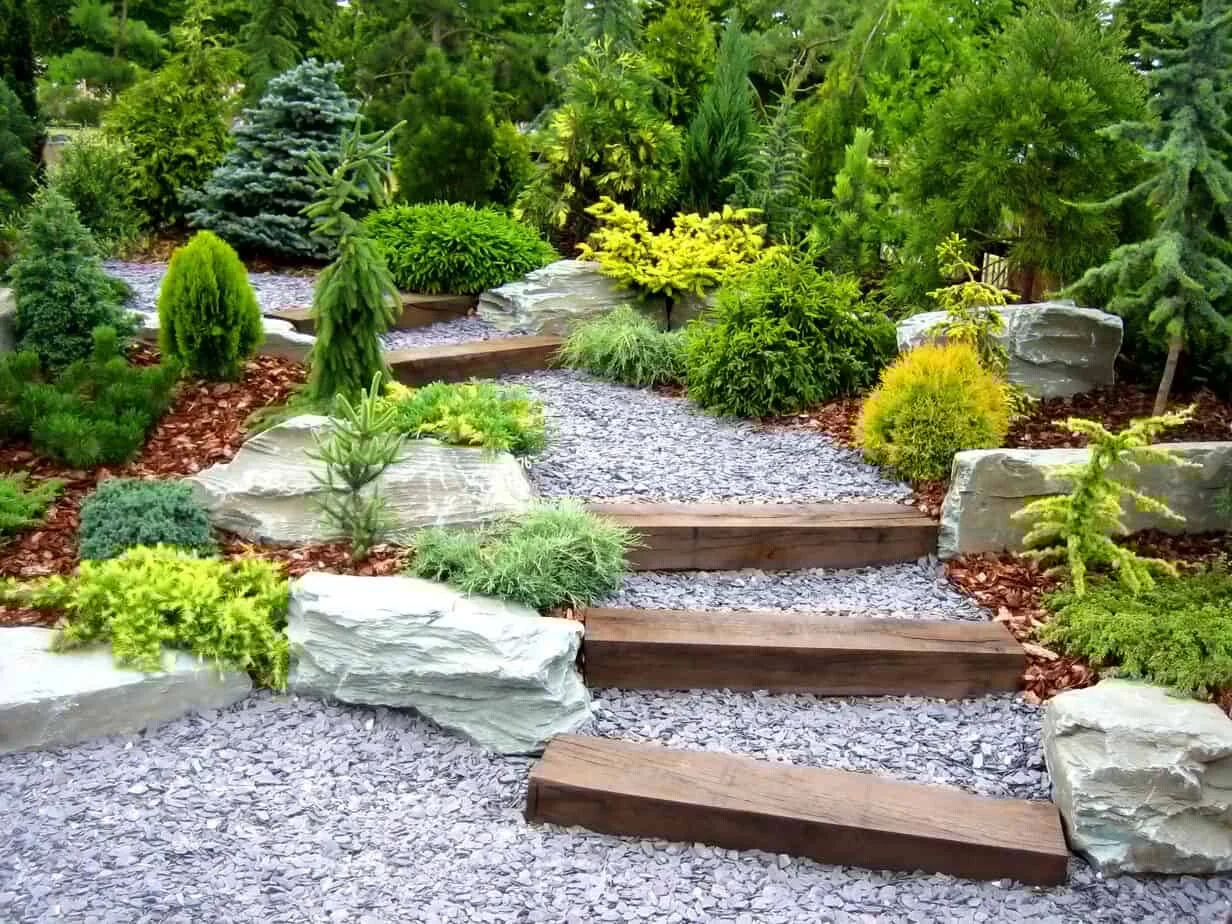 Loose stone walk way with wooden steps and rock décor